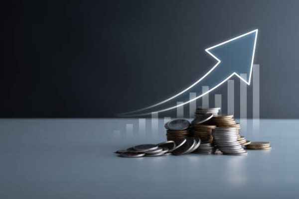 Financial trending increase in economy and business development, gold and silver coins stacking up with graphs. Increase in return on stock market, mutual funds, savings and long term investments.